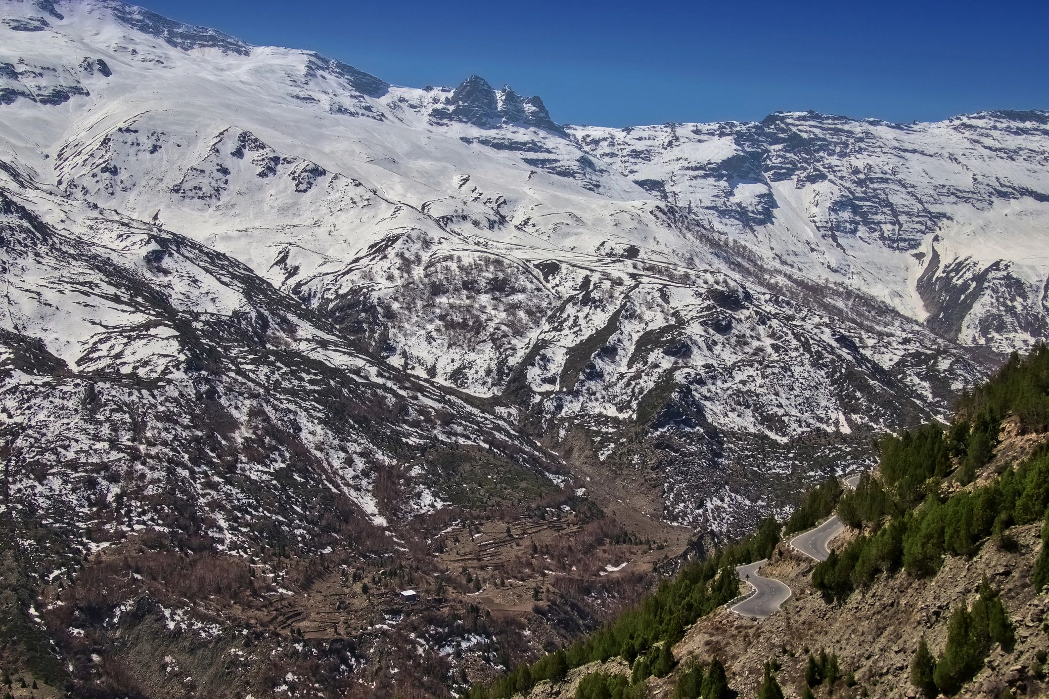 Mountain road with snowy peaks in Lahaul Valley