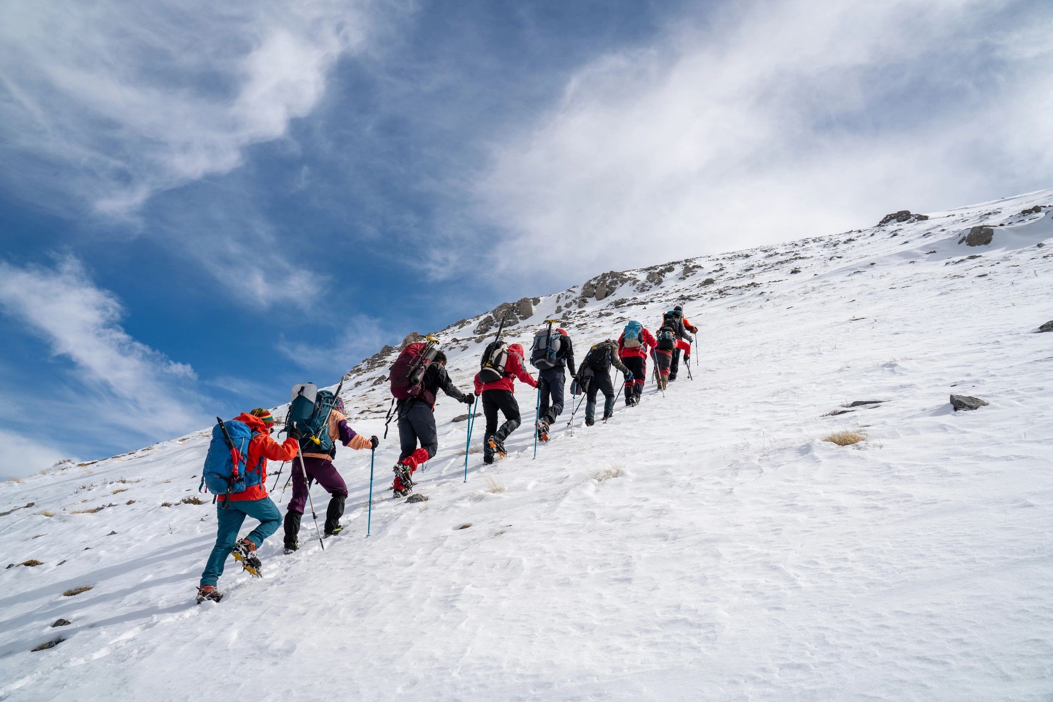 Trekking team walking toward a mountain summit