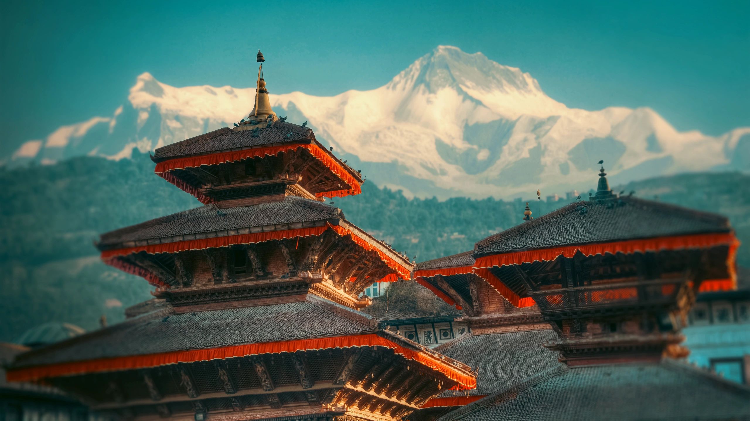 Traditional Himalayan temple with snow-capped mountains in the background